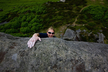 Man climbing steep rock face