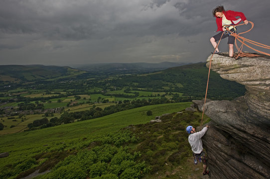Rock climbers scaling steep rock face