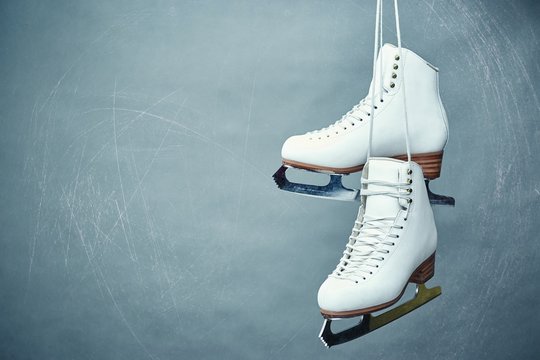 Women's skates with laces on a gray background.