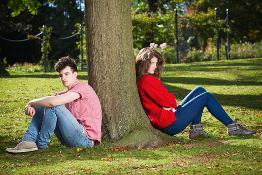 Teenage Couple Arguing In Park