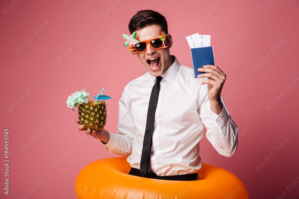 Sticker Happy man in sunglasses and official shirt showing cocktail and international passport