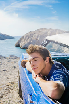 Man In Car Leaning Out Window