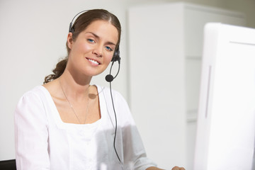 Smiling woman at computer desk