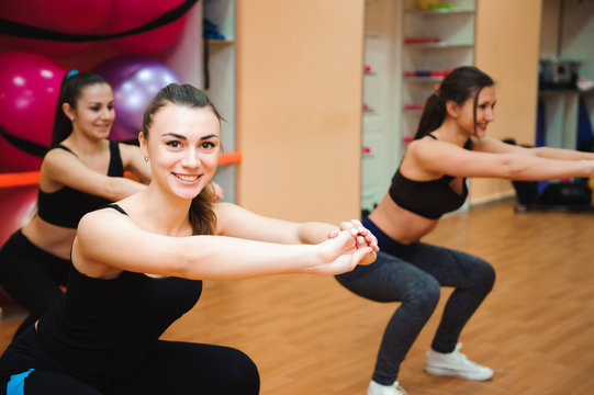 Beautiful women exercising aerobics in fitness club