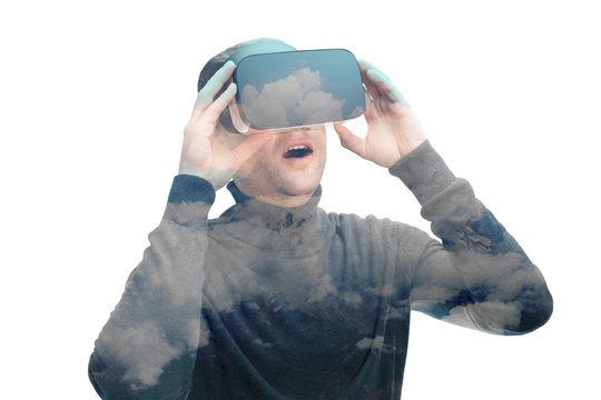 Indoors close up shot of male in black amazed by VR glasses on white background