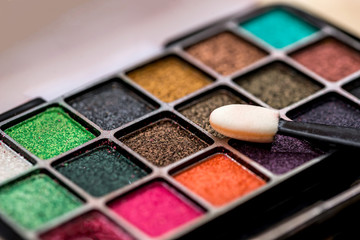 paint for a make-up on a wooden table