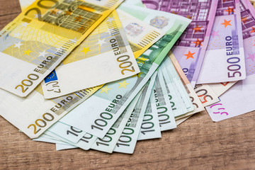 100, 200 and 500 euro banknotes on desk