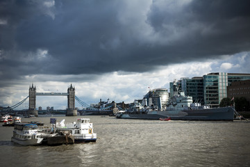 HMS Belfast and Tower Bridge under moody skies