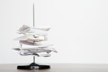 A letter spike with paper on it