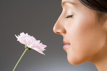 A woman smelling a flower