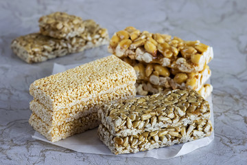 Nuts and seeds with caramel on a white paper.