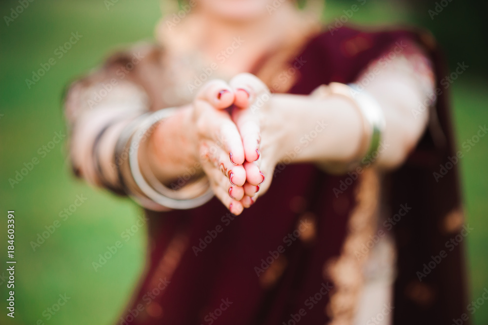 Wall mural mehndi tattoo. woman hands with black henna tattoos. india national traditions