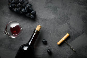 Red wine bottle on a wooden background