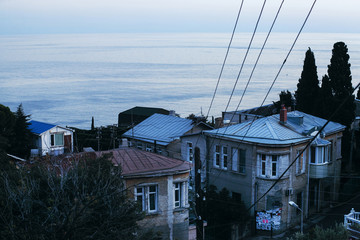 A view of the city houses on the background of the sea.