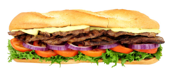 Beef steak and salad filled crusty baguette sandwich isolated on a white background