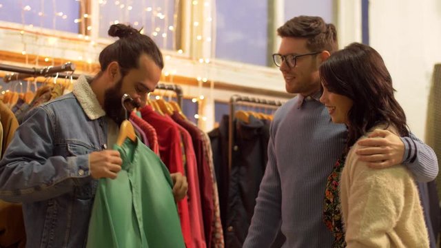 friends choosing clothes at vintage clothing store