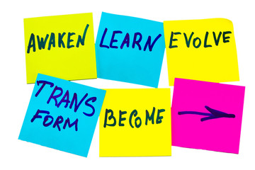 awaken, learn, evolve, transform and become - inspirational new year goals or resolutions - colorful sticky notes on the white background