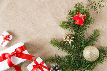 Greeting card. White gift boxes with ribbons and Christmas tree on the hot sandy tropical beach. Christmas and New Year concept. Empty place for a text.