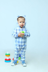 Cute Little Baby Boy Playing Toys.People, children, childhood concept - Cute little baby boy wearing on sleepwear standing. 