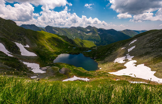 glacier lake Capra in Southern Carpathians. beautiful summer landscape with gorgeous sky in Fagaras Mountains of Romania