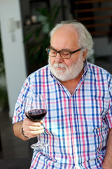 Mature man drinking wine