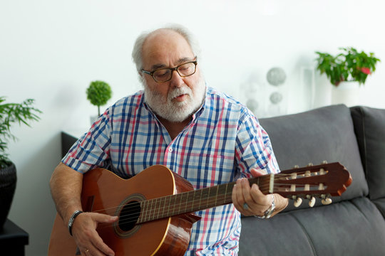 Retired man playing guitar