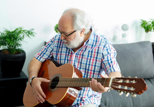 Retired man playing guitar