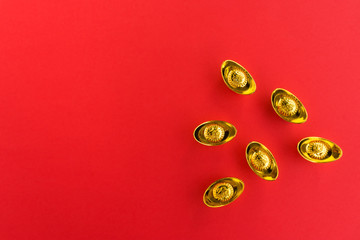 Obraz na płótnie Canvas Chinese New Year Background - Golden Ingots with Chinese Character Happiness and Prosperity on Red Background.
