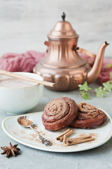 Close-up of a large cup of hot chocolate and fresh homemade cinnamon rolls on a vintage background. Close-up, selective focus, shallow depth of field