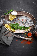 Fresh raw dorado fish on black background, top view