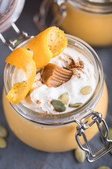 Pumpkin milkshake with salted caramel, orange, seads and wipped cream