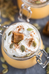 Pumpkin milkshake with salted caramel, orange, seads and wipped cream