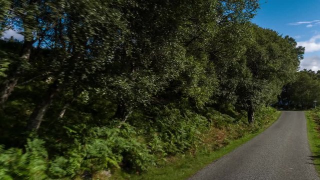 hyperlapse POV shot from a camera attached to the front of a vehicle driving through beautiful empty roads in the scottish highlands