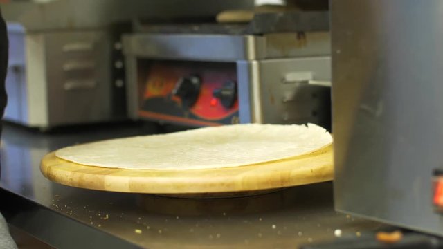 chef hands cutting pita flat bread at kebab shop