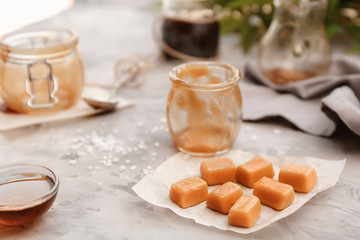 Tasty caramel candies on table