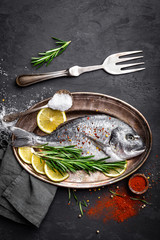 Fresh raw dorado fish on black background, top view