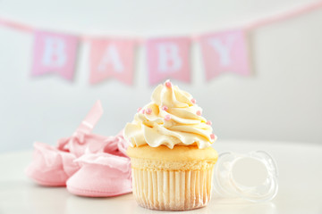 Tasty cupcake for baby shower party on table