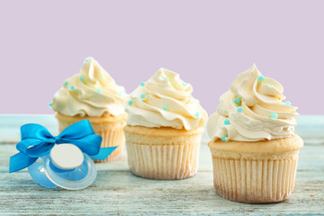 Tasty cupcakes for baby shower party on table