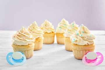 Tasty cupcakes for baby shower party on table
