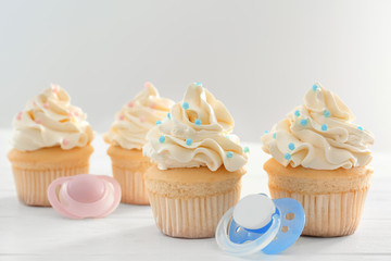 Tasty cupcakes for baby shower party on table