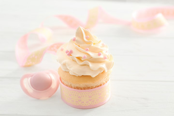 Tasty cupcake for baby shower party on table