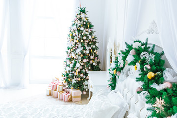 Christmas living room with a Christmas, gifts tree and bed. Beautiful New Year decorated classic home interior. Winter background