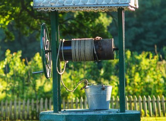 The well and the bucket are on top