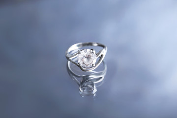 Beautiful engagement ring on reflective surface