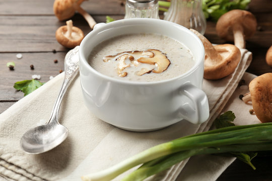 Bowl of creamy shiitake mushroom soup on table