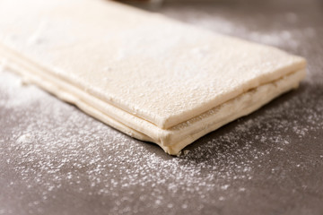 Flaky dough sheets on table, closeup