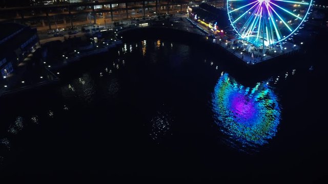 Abstract Aerial View of Ferris Wheel Reflection in Night Water