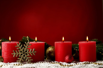 Christmas candles with fir-tree branches and baubles