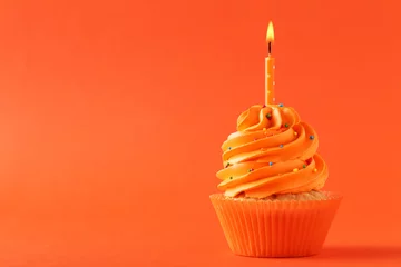  Tasty cupcake with candle on orange background © 5second