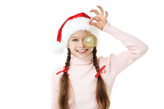 Young girl in santa hat with bauble on white background